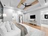 Primary suite with vaulted beamed ceiling and view to the bath