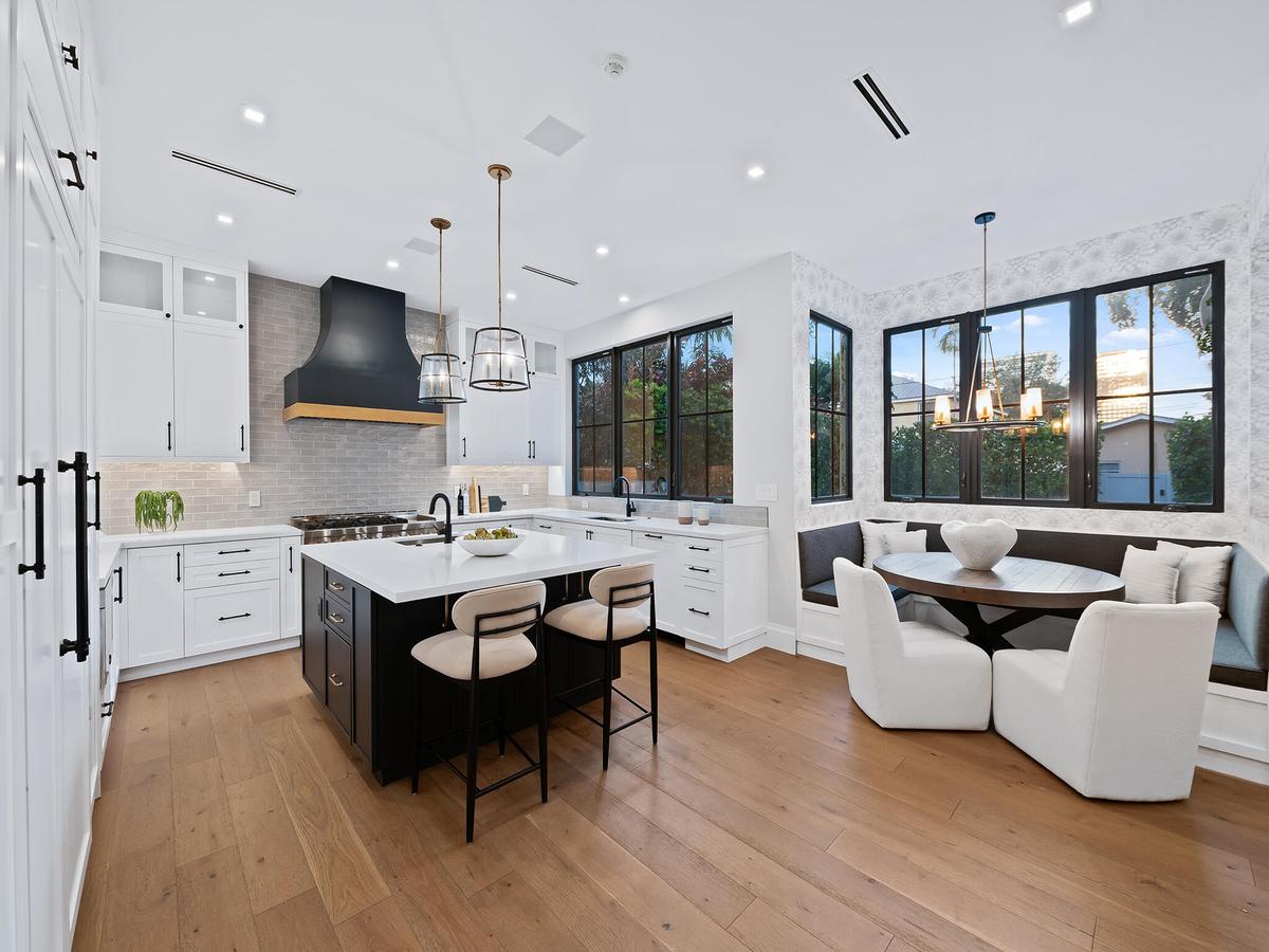 Chef's kitchen with white shaker cabinetry and charcoal island