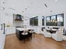 Chef's kitchen with white shaker cabinetry and charcoal island