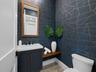 Powder room with geometric wallpaper