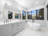 Primary bathroom with double vanity and freestanding tub