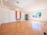 Herringbone wood-finish flooring, recessed lighting, crown molding with ambient lighting, a built-in fireplace, and a contemporary chandelier