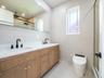 Dual vanity with matte black fixtures and a white countertop