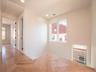 Herringbone wood-finish flooring, recessed lighting, and white walls