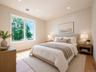 Recessed lighting, large window, light-toned walls, wood-finish flooring
