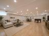 Recessed lighting throughout, wood-finish flooring, light-toned walls, and a window for natural light