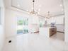 Modern kitchen featuring a large central island with integrated appliances and a waterfall countertop