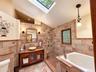 Cathedral ceilings with skylight.  Stone shower and deep soaking custom tub