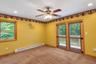 Recessed lighting, ceiling fan, wood-frame window, and glass-paneled double doors providing exterior access