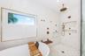 Tub with large modern shower and natural lighting