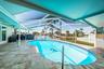Travertine pavers surround the pool