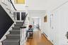 Foyer entrance featuring baseboard heating, light wood finished floors, ornamental molding, and stairway