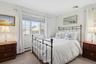 Bedroom featuring carpet floors and a baseboard heating unit