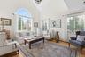 Living room featuring high vaulted ceiling and light wood-type flooring