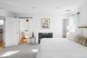 Carpeted bedroom featuring multiple windows and ensuite bath