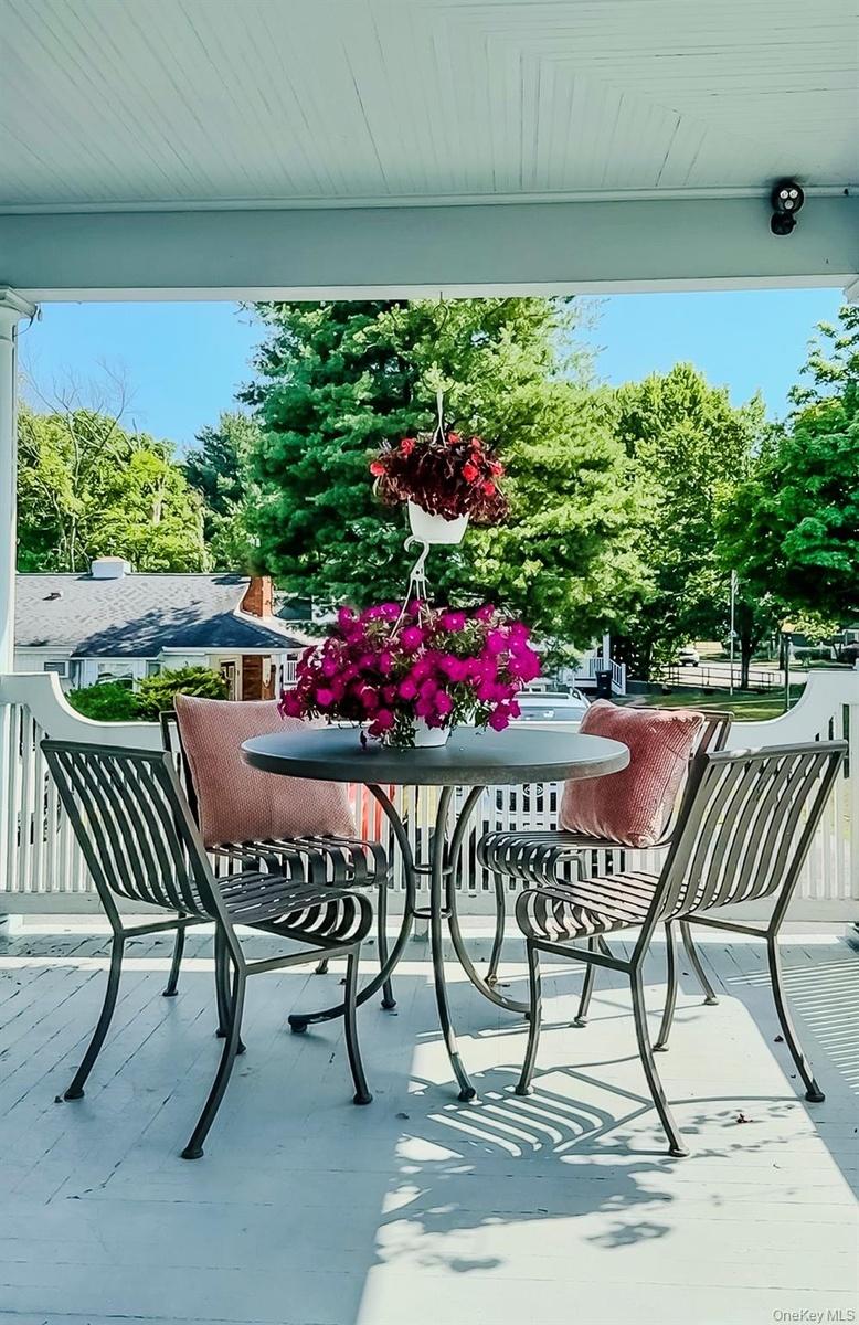 A wide covered porch and part of Outside Living Spaces