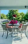 A wide covered porch and part of Outside Living Spaces