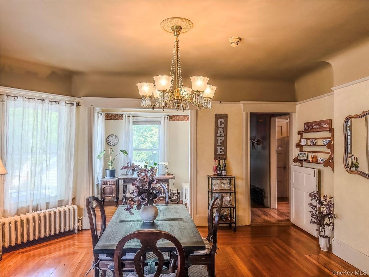 Main House Dining Hardwood flooring, bay window and chandelier lighting