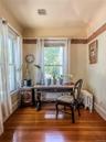 Office Nook off Dining Room with hardwood flooring, painted walls with decorative border and white trim
