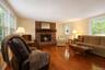 Spacious Living Room with wood burning fireplace and beautiful Hardwood floors