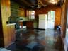 Charming kitchen with wood burning stove, slate floor, knotty pine cabinets and a dutch door!