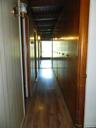 Floor to ceiling knotty pine cabinets all the way down the hallway, storage galore