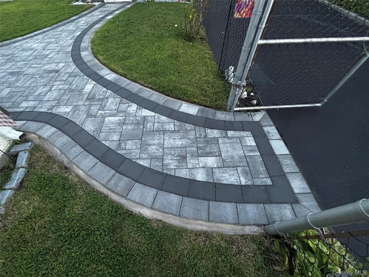 Sidewalk Pavers leading to Garage or Rear Entrance of Home.  2 Years Young and Sealed Professionally.