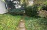 Exit from basement leasing around side of home by stone pathway