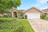 Artisan-pavers and lush landscaping greet you upon arriving at this stunning single-level home.