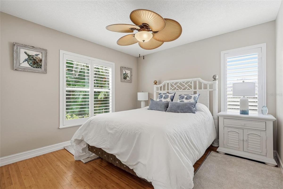 Guest bedroom with adjacent pool bathroom.