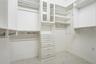 Wow! The primary walk-in closet is stunning with amazing custom shelving.