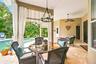 Cabana-style curtains frame the covered patio peering to the pool.
