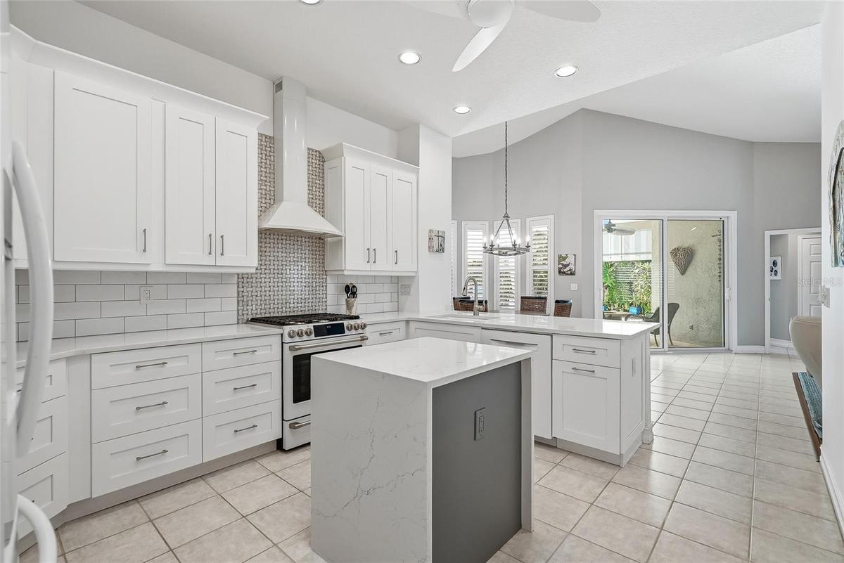 Absolute showstopper kitchen with electric-enhanced island, vented range hood, amazing cabinet and pantry space.