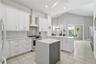 Absolute showstopper kitchen with electric-enhanced island, vented range hood, amazing cabinet and pantry space.