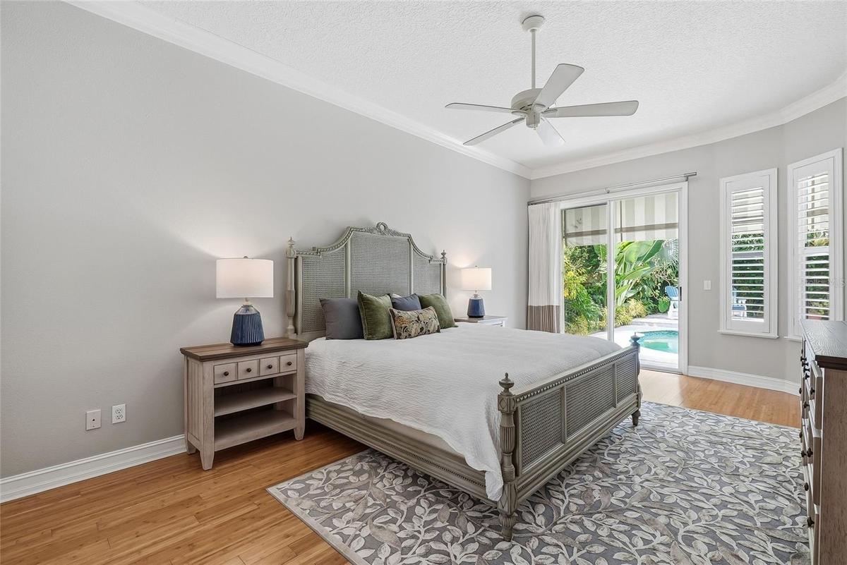 Oversized primary bedroom with a glimmering view of the pool.