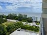 Coastal setting with ocean, road frontage, and lush landscaping