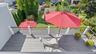 View down to private balcony off second floor primary suite and the deck on the first floor off the kitchen,