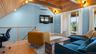 Vaulted ceiling, glass doors to third floor balcony.