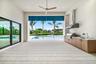 Covered loggia with an Outdoor Kitchen overlooking the pool and lake.
