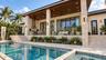 Patio with full outdoor kitchen, heated saltwater pool and hot tub spa. Virtually staged.