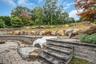 All new retaining walls and stone staircase with area for a hot tub.