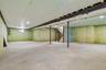 Spacious unfinished lower level with concrete flooring, recessed lighting, exposed ceiling joists, and a window