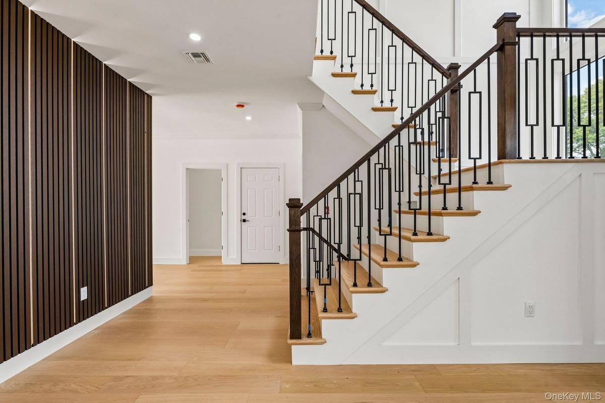 Hardwood flooring with a modern wood slat accent wall