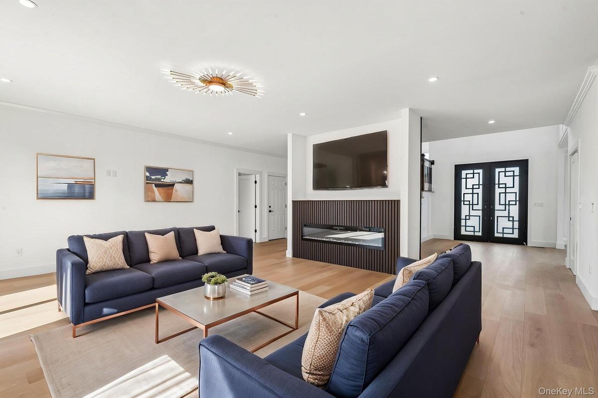 Recessed lighting, wood-finish flooring, and a decorative ceiling fixture