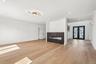 Expansive room featuring light wood-finish flooring and recessed lighting
