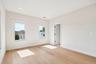 Recessed lighting, light wood-finish flooring, white trim, and two pane windows