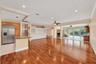 Expansive room with wood-finish flooring, recessed lighting, and crown molding. All wall color has been virtually enhanced.