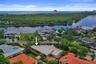 Oversized lot, lush landscaping with mature palm trees, and a spacious backyard.