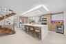 Chef's kitchen with impressive waterfall island and top of the line appliances