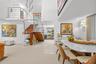 Bright, open living and dining space with a sculptural staircase